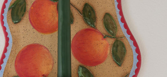 An upclose shot of an orange painted candle holder.