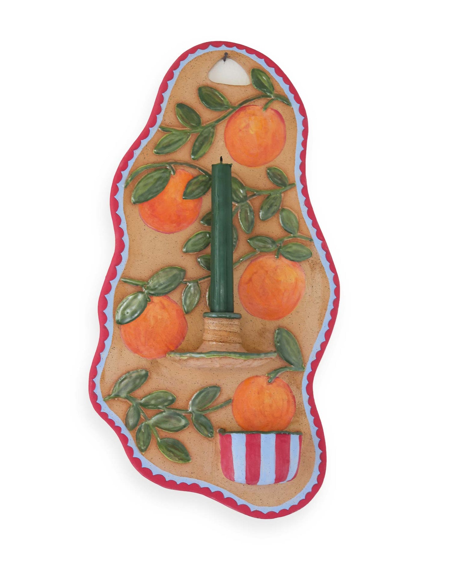 Decorative candle holder with oranges and a candle on a white background
